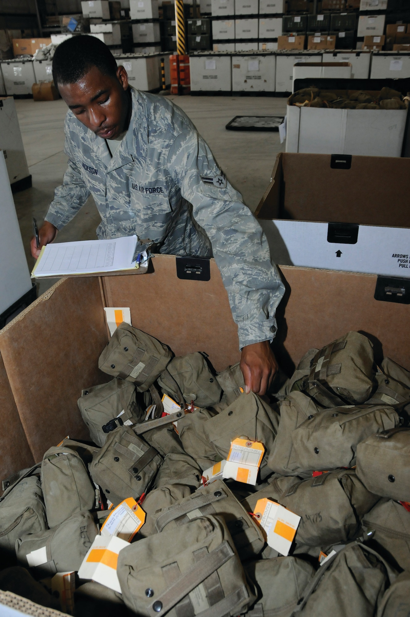 Airman 1st Class Demetrius Jackson, 379th Expeditionary Logistics Readiness Squadron,grabs another Individual First Aid Kit (IFAK) from a full box of IFAKs to check off his list Aug. 19, 2008. The IFAKs are checked to make sure they match up with their DD form 1574 (serviceable tag - material). Items inside the IFAKs are checked for expiration dates to ensure they are serviceable.  Airman Jackson is a member of the team revitalizing the IFAKs, part of the recertification process to get them back into use supporting Operations Iraqi and Enduring Freedom and Joint Task Force-Horn of Africa.  Airman Jackson a native of New Orleans is deployed to this undisclosed location in Southwest Asia from Holloman Air Force Base, N.M.  (U.S. Air Force photo by Tech. Sgt. Michael Boquette/Released)