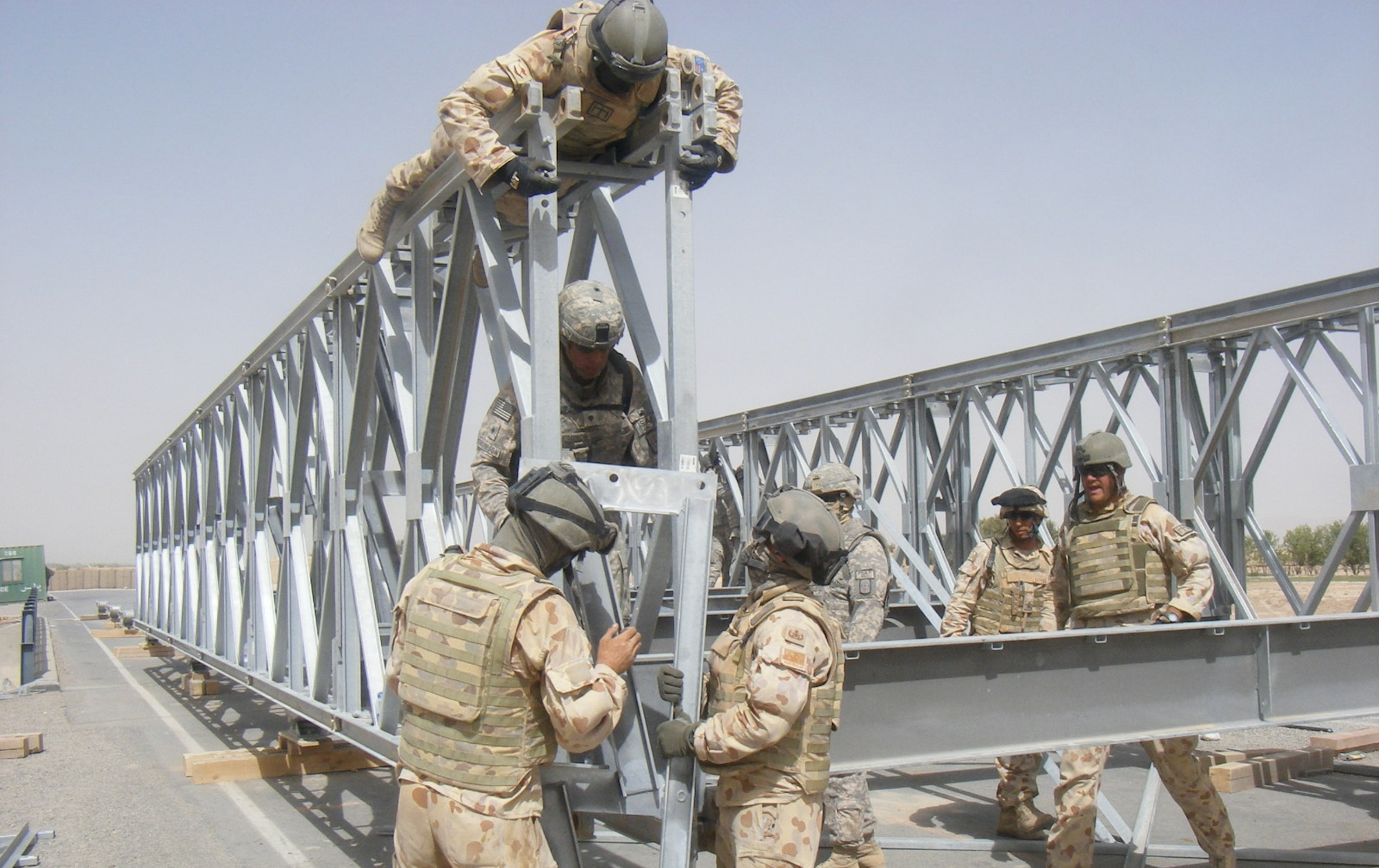 Putting the pieces together, Australian and American Combat Engineers construct the Mabey Johnson Bridge.  (U.S. Army photo/ Capt. James Reid)