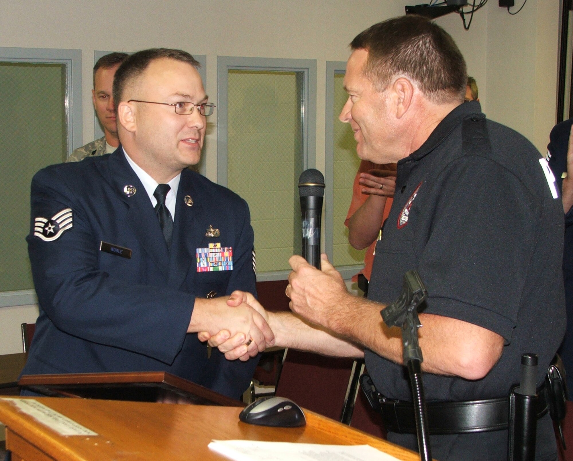 Staff Sgt. Noland Noble, Jr., 88th Security Forces Squadron at Wright-Patterson Air Force Base, is presented a certificate of appreciation by Beavercreek, Ohio Police Chief John Turner August 25.  Noble's fast actions while off-duty rendering aid to the victim of a purse snatching in July contributed to the capture of two suspects sought for a number of crimes.  (Photo courtesy City of Beavercreek/Richard Diaz)