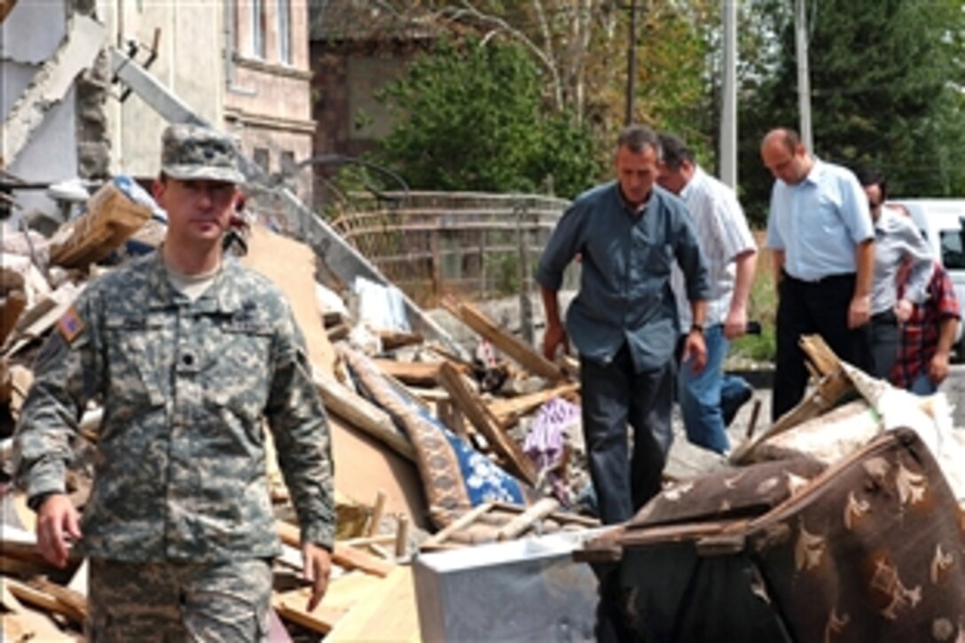 U.S. Army Lt. Col. Otto Fiala, left, Georgian government officials and local residents gather information on the situation in Gori, Georgia, Aug. 25, 2008. The team is assessing the damage, relief efforts and return of displaced persons as part of the larger U.S. response to Georgia’s request for humanitarian assistance. 