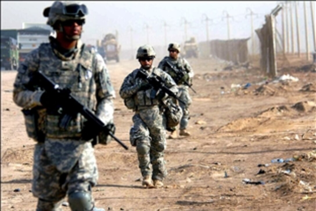 U.S. Army soldiers patrol the streets in Abu Dashir, Baghdad, Iraq, Aug. 19, 2008. The soldiers are assigned to the 4th Infantry Division's Headquarters Detachment, 1st Brigade Combat Team. 
