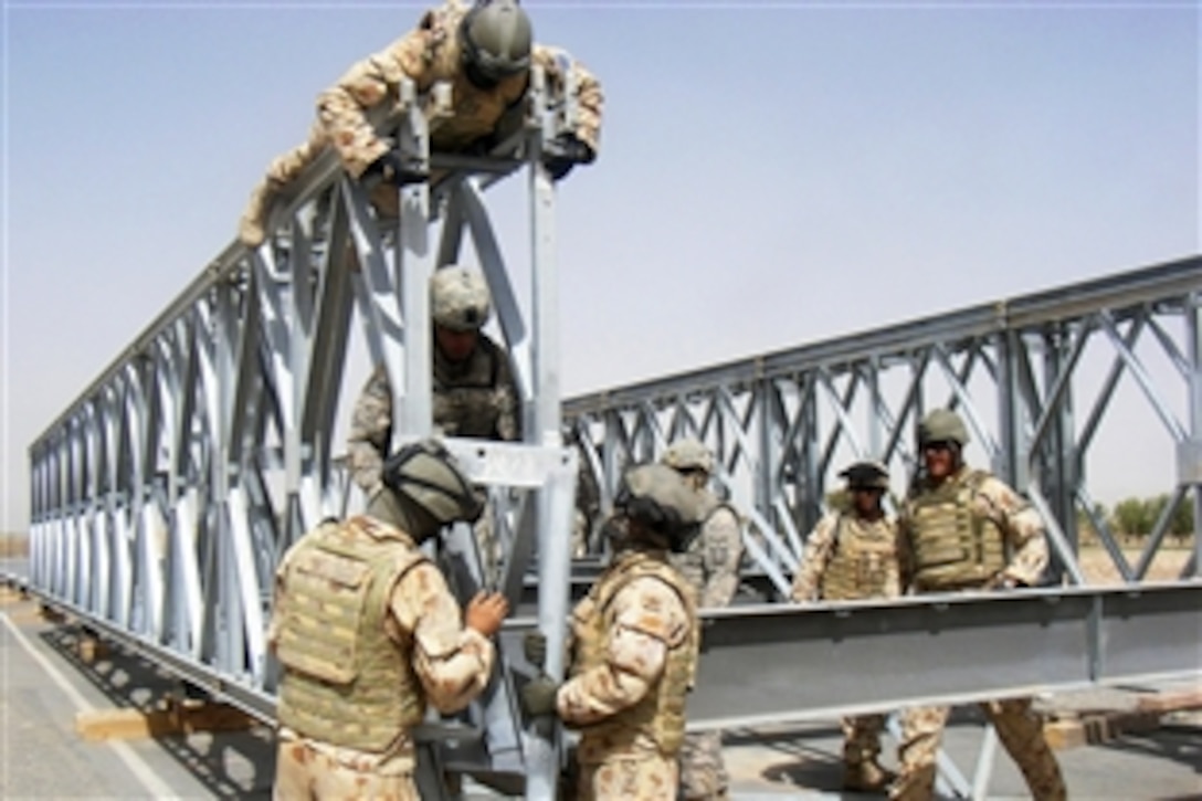 American and Australian combat engineers rebuild the Mabey Johnson Bridge near Andar and Moqur in eastern Afghanistanin, Aug. 25, 2008. The U.S. soldiers are assigned to the 420th Engineer Brigade and the Australian soldiers are assigned to an Australian reconstruction task force.