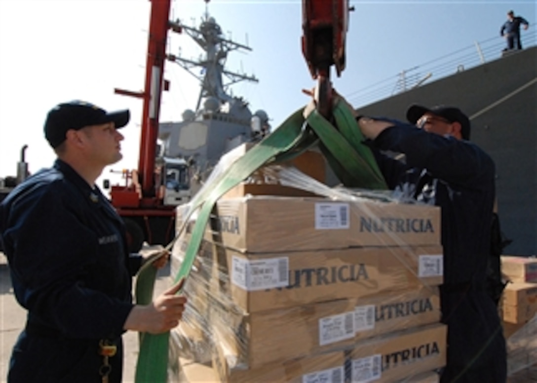 U.S. Navy Petty Officer 1st Class Jeff Weaver and Petty Officer 2nd Class Gary Smith prepare humanitarian aid supplies in Souda Bay, Crete, to be loaded aboard the USS McFaul (DDG 74) on Aug. 20, 2008.  Approximately 55 tons of humanitarian assistance is being loaded for shipment to Georgia.  