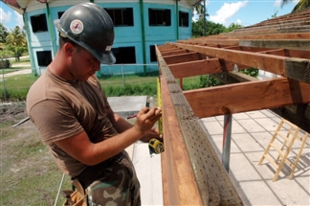 U.S. Navy Seabee Steven Cline, of Navy Mobile Construction Battalion 133, makes adjustments during the reconstruction of the Mwan Elementary School as part of an engineering civic action program in Chuuk, Micronesia, on Aug. 23, 2008.  Pacific Partnership is an exercise that provides local communities with various medical, dental and engineering civic action programs focused on humanitarian assistance.  