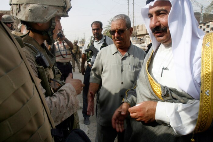 FALLUJAH, Iraq (Aug. 27, 2008) – Chief Warrant Officer 2 Byron Yoshida (left), team leader, Civil Affairs Team 2, talks to leaders of the Fallujah City Council during a media briefing in Fallujah Aug. 27.  The team is near completion of project to deliver 35 generators throughout the city. The generators were placed in residential areas to provide power to homes as a temporary solution to Fallujah’s absence of the city-wide utility service. (Official U.S. Marine Corps photo by Cpl. Chris Lyttle) (RELEASED)