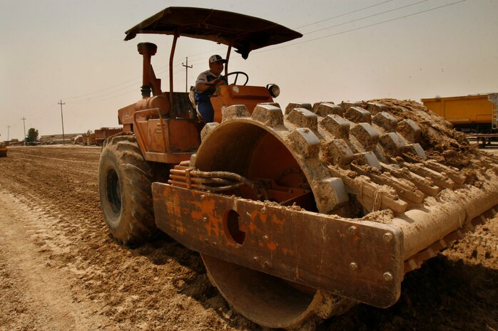 FALLUJAH, Iraq (September 2, 2008) – An Iraqi worker levels out dirt and prepares it for paving a new entry control point (ECP) to Fallujah, Aug. 26. Coalition forces and the Fallujah City Council (FCC) here are overseeing a road construction project to better facilitate commercial truckers entering the city. (Official U.S. Marine Corps photo by Cpl. Chris Lyttle) (RELEASED)