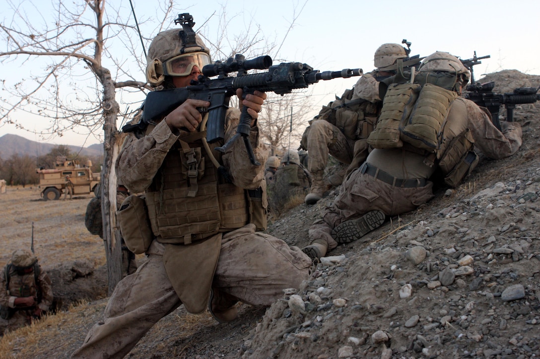 Lance Cpl. Bryan E. McDonald III, a designated marksman assigned to third platoon, Company F, Task Force 2d Battalion, 7th Marine Regiment, 1st Marine Division, and a Denton, Texas native, searches for enemy fighters during the initial assault of a Taliban-held compound, Aug. 28. (U.S. Marine Corps photo by Cpl. James M. Mercure)