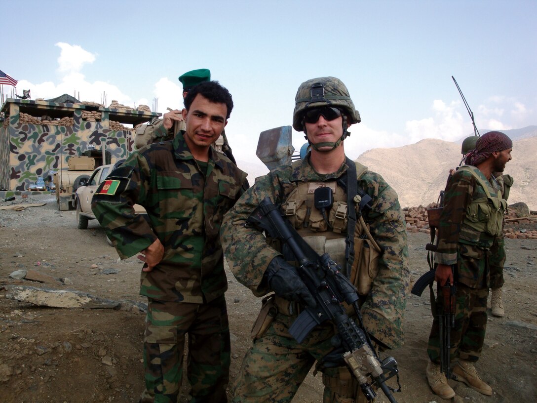 Sgt. Joshua Mathes stands with Afghan National Army soldiers in Laghman Province, Afghanistan, where he was responsible for training during his seven-month deployment to Afghanistan as part of Embedded Training Team 5-5, Regional Corps Advisory Command 3-7. Mathes was one of three Marines responsible for the training of three ANA reconnaissance platoons and a field artillery platoon.