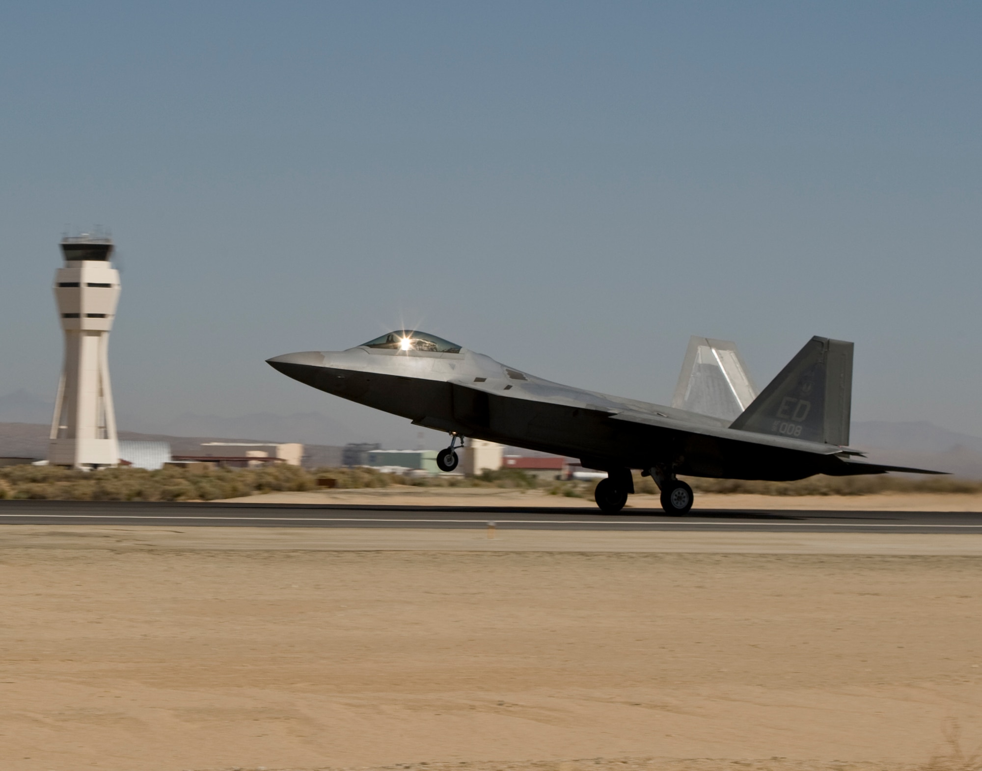 An F-22 Raptor takes off from an Edwards runway Aug. 28 to undergo an aerial refueling testing using an alternative jet engine fuel -- the first for an Air Force aircraft. The fuel is a 50/50 mix of JP-8 jet fuel and a natural gas-based fuel. The KC-135 came from March Air Reserve Base, Calif. (Lockheed Martin photo)