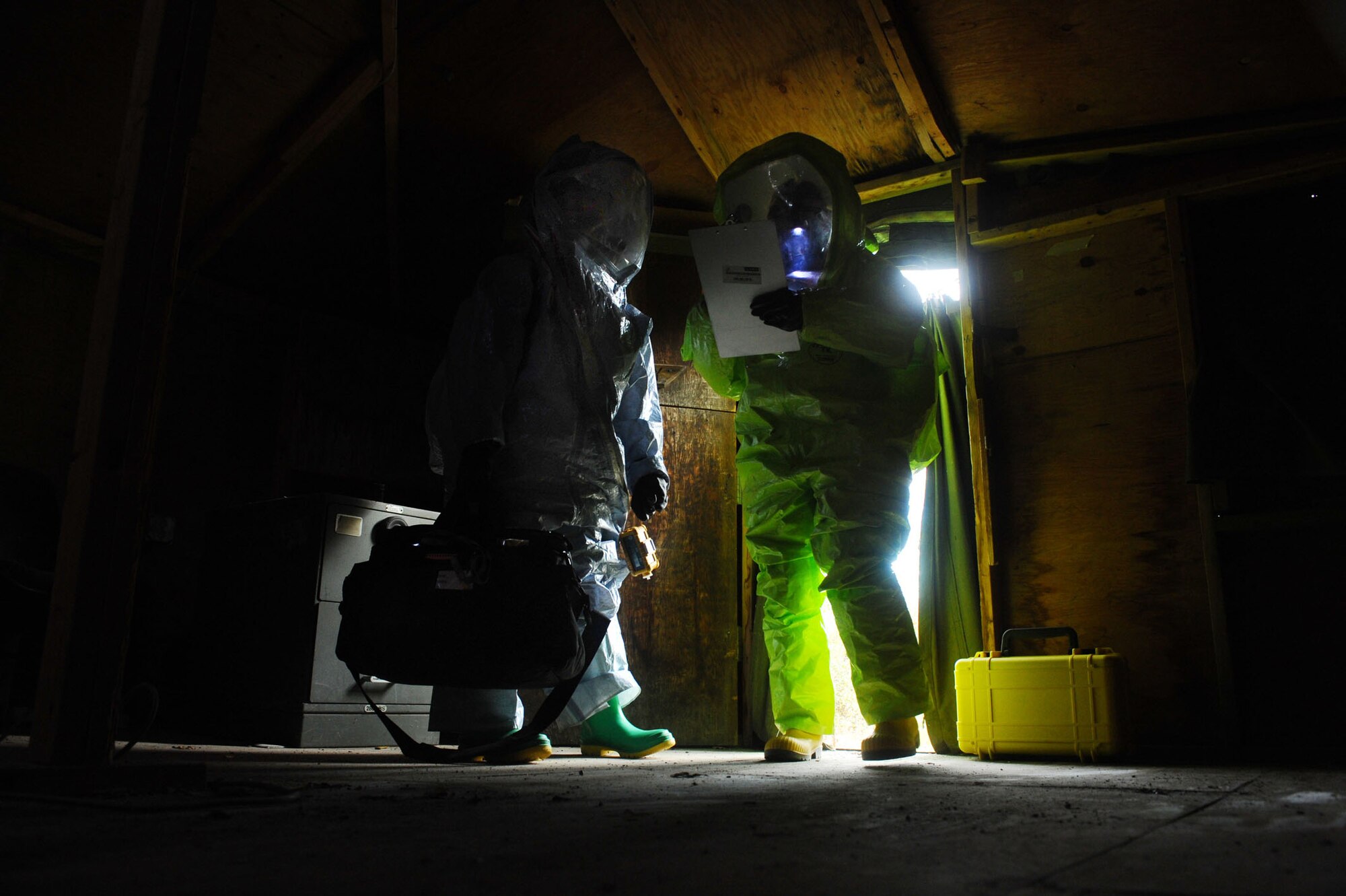 Staff Sgt. Michael Huntington, right, and Airman Tiffany Averill, left, enter the contaminated area with the improvised explosive device containing an unknown white powdered substance attached to it Aug. 28, 2008, at Eielson Air Force Base, Alaska. Airmen of the 354th Civil Engineer Squadron readiness flight conducted a training exercise to respond to an improvised explosive device with a white, powdered substance attached to it. This exercise helps them maintain their certification and gain experience on handling this type of situation. Both are assigned to the 354th CES readiness flight.  (U.S. Air Force photo by Airman 1st Class Jonathan Snyder)