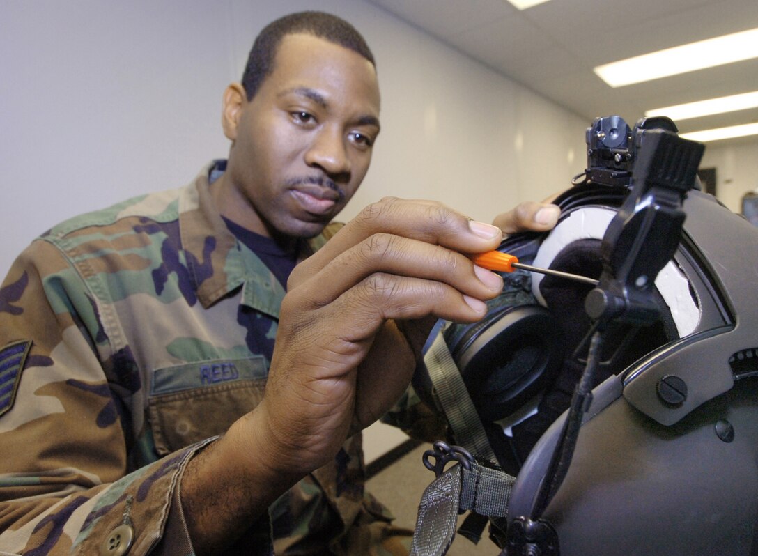 Tech. Sgt. Marcus Reed, 1st Helicopter Squadron Aircrew Flight Equipment assistant NCO in charge, performs maintenance on a helmut microphone. Routine maintenance is performed on the helmuts every 90 days.