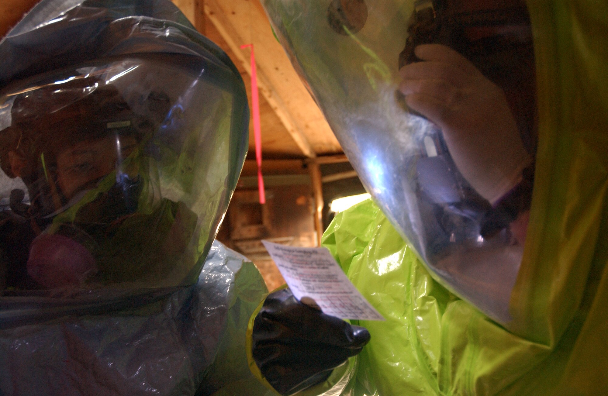 Staff Sgt. Michael Huntington and Amn Tiffany Averill of the 354th Civil Engineer Squadron read off of an instruction checklist to operate a DoD Biological Sampling Kit at a hazardous readiness exercise on Aug. 28, 2008. The sampling kit will help to identify various biological agents. (U.S. Air Force photo/Airman 1st Class Willard E. Grande II)