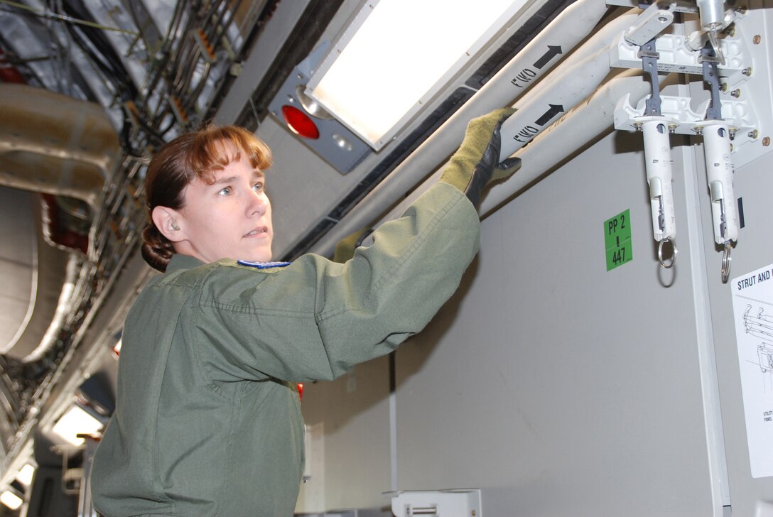 Senior Airman Karen Helmick removes a litter apparatus on the C-17 Globemaster during Aeromedical Evacuation Jamboree 2008, part of a joint effort by the 932nd Airlift Wing and the 375th Airlift Wing who hosted JAMBOREE participants who were able to get a good variety of training on three different airplanes. Photo by Tech. Sgt. Dan Oliver  
