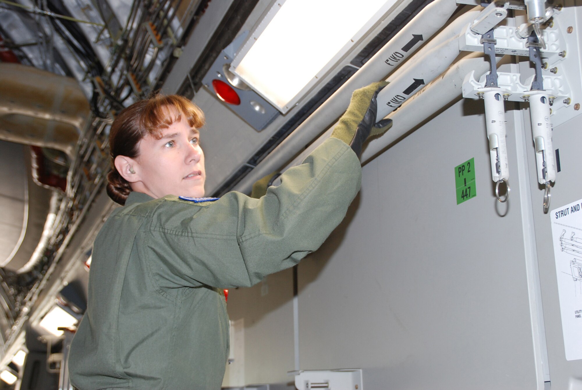 Senior Airman Karen Helmick removes a litter apparatus on the C-17 Globemaster during Aeromedical Evacuation Jamboree 2008, part of a joint effort by the 932nd Airlift Wing and the 375th Airlift Wing who hosted JAMBOREE participants who were able to get a good variety of training on three different airplanes. Photo by Tech. Sgt. Dan Oliver  