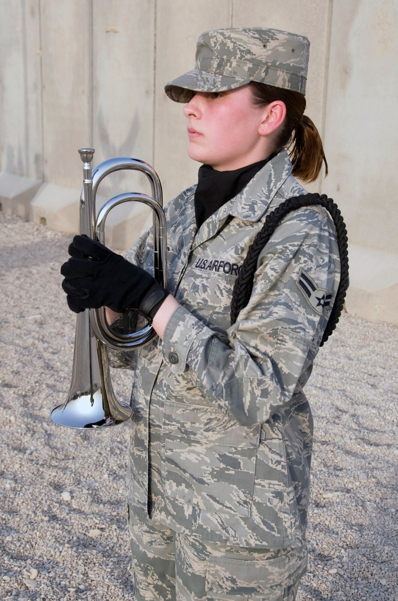 Airman 1st Class Caitlin Davies, an honor guard member at Ali Base, Iraq, stands ready to sound Reveille Aug. 21.  Airman Davies is assigned to the 407th Expeditionary Communications Squadron here and is deployed from the 31st Combat Communications Squadron at Tinker Air Force Base, Okla. (U.S. Air Force photo/Airman 1st Class Christopher Griffin)
