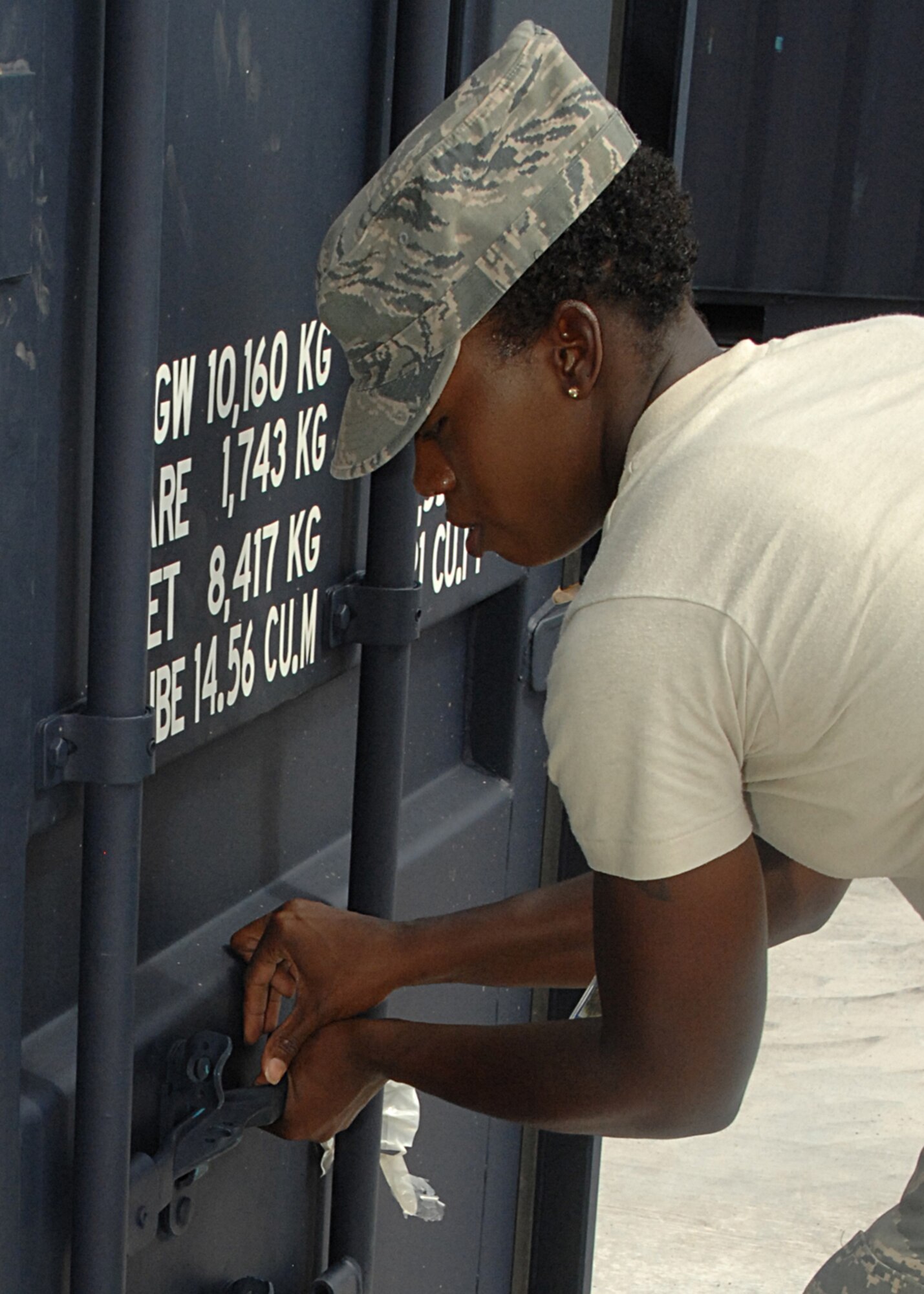 Tech. Sgt. Genese Williams, Materiel Management-Billeting Assistant non-commissioned officer in charge, locks a container after helping conduct 100 percent inspection on the contents. (U.S. Air Force photo/Staff Sgt. Terri Barriere)