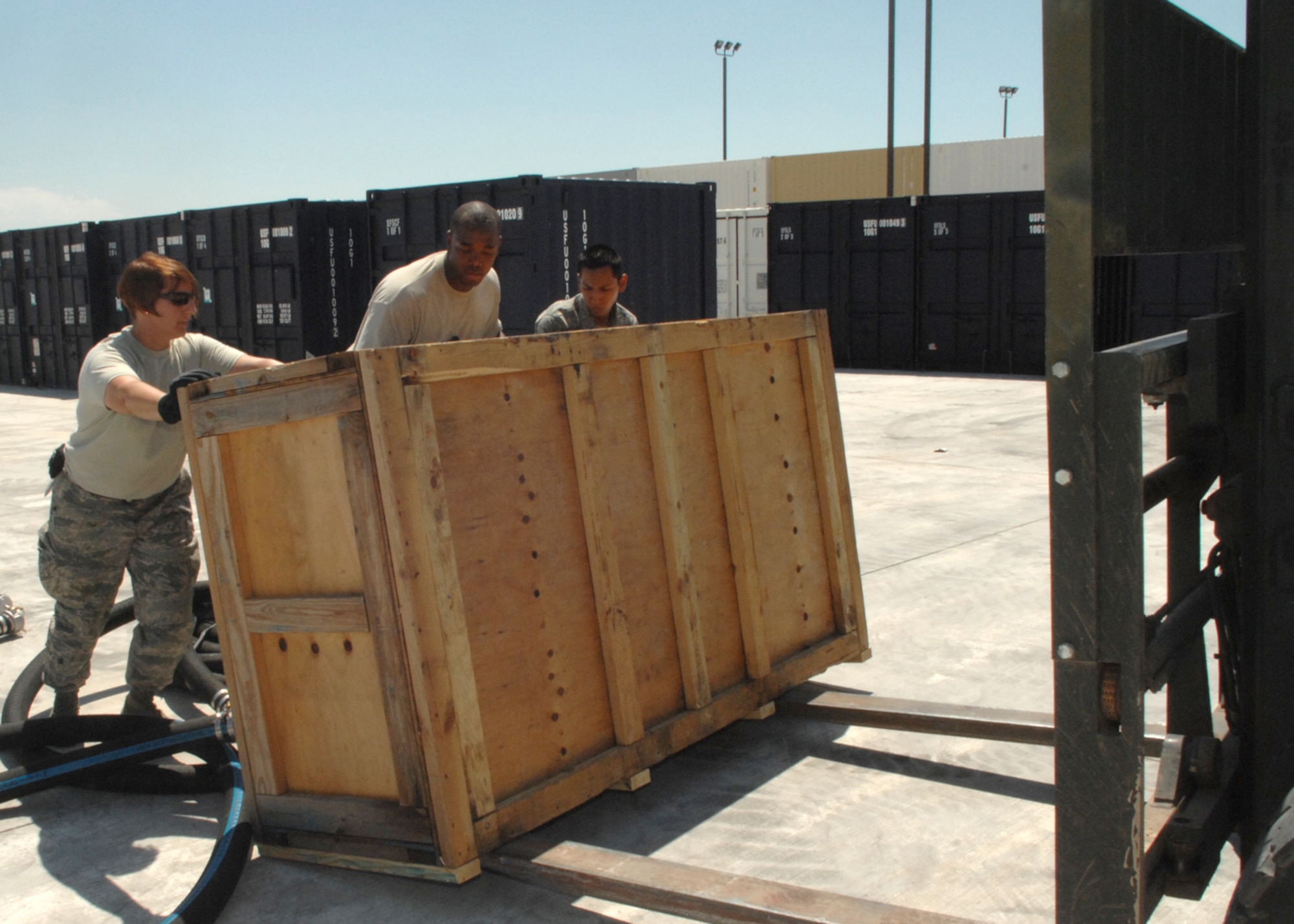 (From left) Tech. Sgt. Kimberly Blaum,  U.S. Air Forces in Europe BEAR representitive, Staff Sgt. Nathaniel Jackson, 49th Materiel Maintenance Support Squadron, and Airman 1st Class Jorge Ontiveros, also from the 49th MMSS, load cargo onto a forklift. (U.S. Air Force photo/Staff Sgt. Terri Barriere)