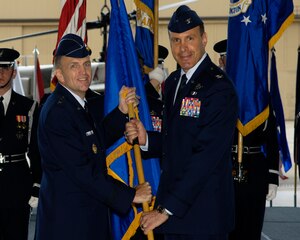 ANDREWS AIR FORCE BASE, Md. -- Maj. Gen. Ralph Jodice, Air Force District of Washington commander, passes the 316th Wing guidon to Col. Steven Shepro on Aug. 28 in Hangar 1 during the Assumption of Command ceremony. Colonel Shepro comes from Balad Air Base, Iraq where he served as vice commader of the 332nd Air Expeditionary Wing.