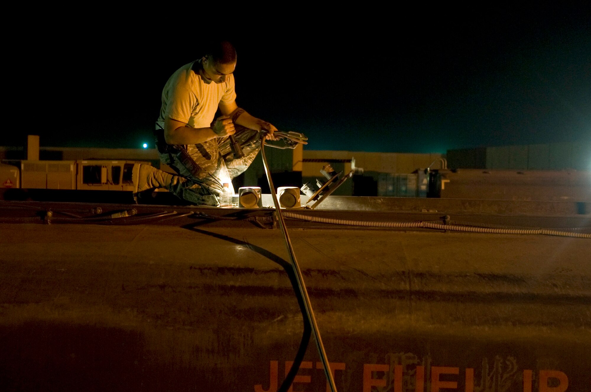 Senior Airman Greg Crews tops off fuel for his truck Aug. 22 at Ali Base, Iraq. The fuels flight supports not only the Air Force, but is a critical asset for the Navy and Army providing the fuel needed 24 hours a day. Airman Crews is deployed from Hurlburt Field, Fla.  (U.S. Air Force photo/Airman 1st Class Christopher Griffin)