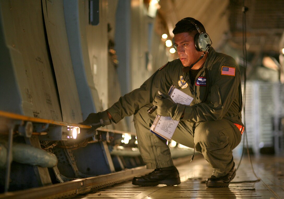 Staff Sgt. Antonio Torres performs a preflight check of a C-5 Galaxy before take-off Aug. 21 at Lackland Air Force Base, Texas.  He is a flight engineer student with the Air Force Reserve's 433rd Airlift Wing at Lackland AFB.  (U.S. Air Force photo/Robbin Cresswell)