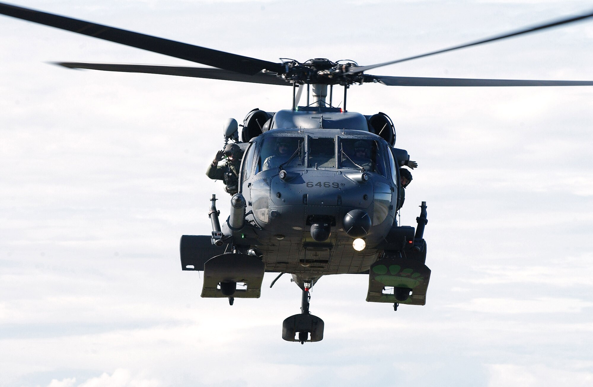 An HH-60 Pave Hawk aircrew wave to Alex Lee Aug. 22 at Eielson Air Force Base, Alaska. Alex was born with congenital heart defects and Down syndrome and was selected by the Make-A-Wish Foundation for the Pilot for a Day program. The purpose of the program is to ease the pain of children who lost a normal childhood due to illnesses or disabilities. (U.S. Air Force photo/Airman 1st Class Jonathan Snyder) 