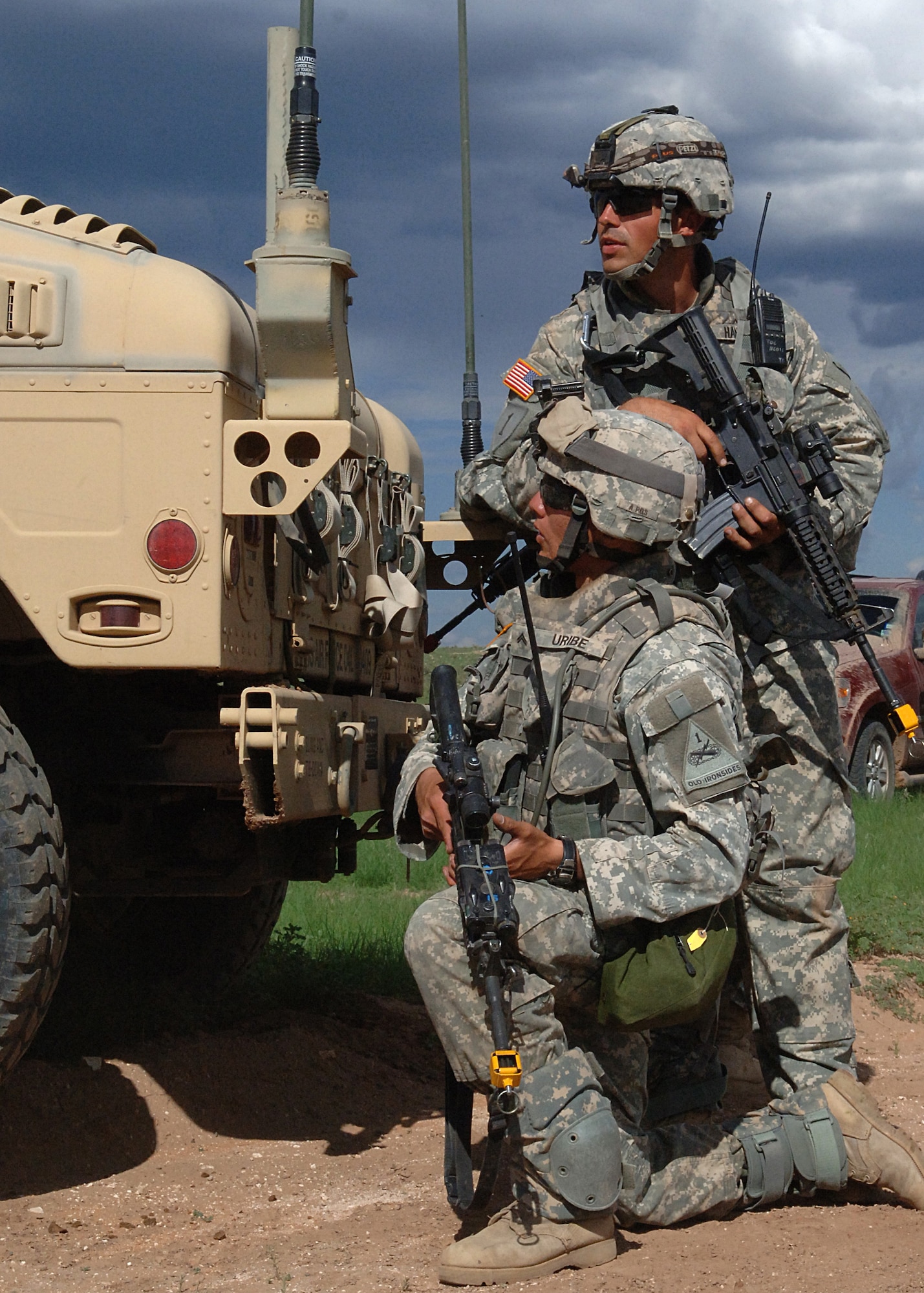 Soldiers from the 1-77th Armor, 4th Brigade, 1st Armor Division, Fort Bliss, Texas, peek from behind their cover while being attacked during a mock exercise Aug. 12, at McGregor Range, New Mexico.  (U.S. Air Force photo by Airman 1st Class John D. Strong II)
