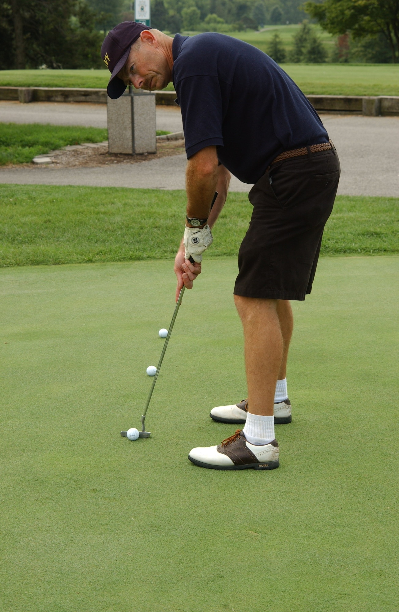 Senior Chief Petty Officer Freeland Peterson, St. Louis Navy recruiter, practices his putting before the 2008 Navy Ball Golf Tournament held Friday at the Clinton Hill Golf Course. Several people participated in the event to raise enough money to allow all Navy personnel to attend the 2008 Navy Ball with a guest at no charge. 

(US Air Force photo/Airman 1st Class Amber Kelly-Woodward)