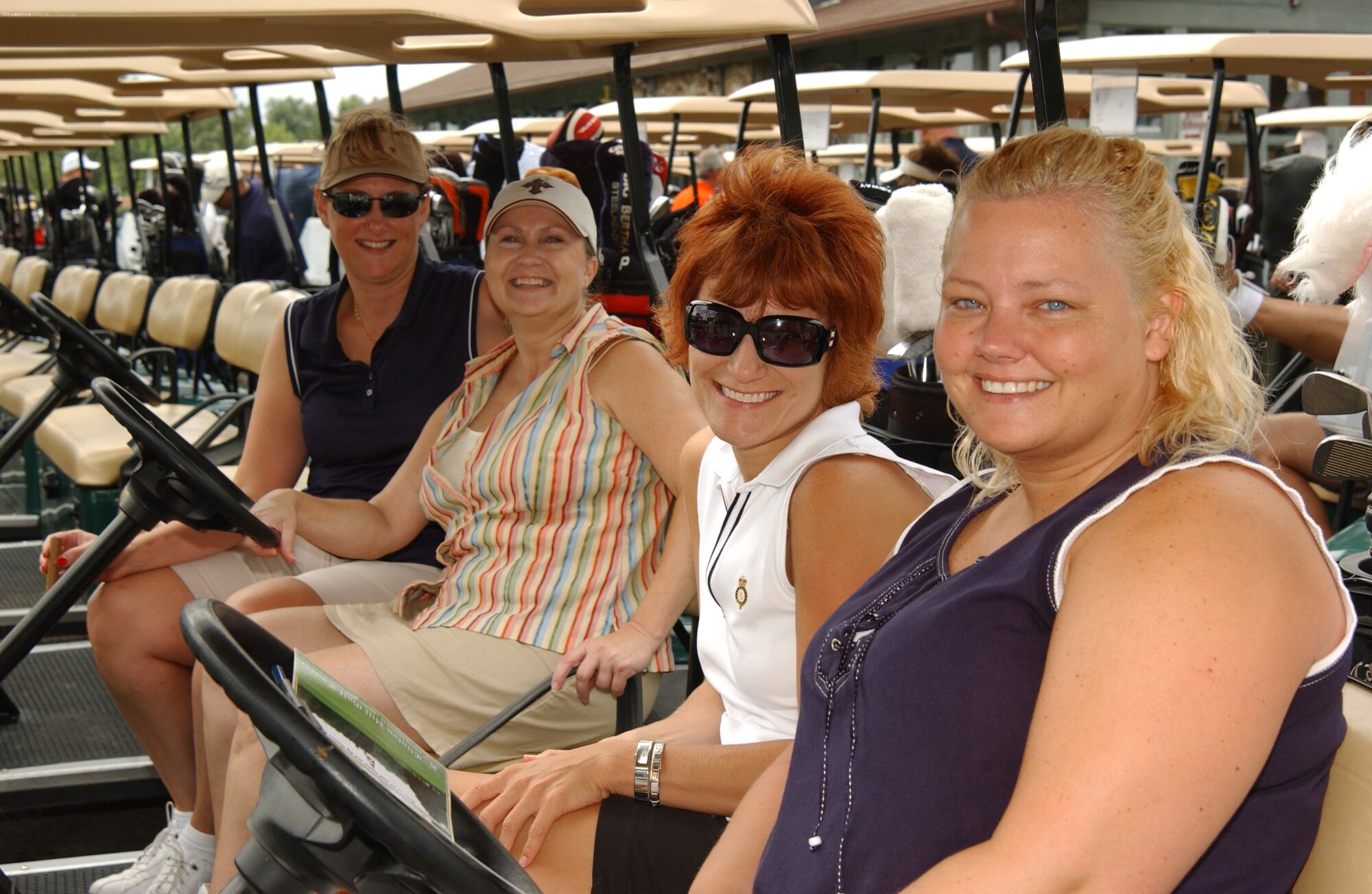 Mary Jo Riech, (right) Michelle Sabin, Cathy Markin and Jo Huffman, all U.S. Transportation Command Federal Software Group contractors, await the start of the 2008 Navy Ball Golf Tournament at Clinton Hill Golf Course Friday. Their group was the only one composed of all females. 

(US Air Force photo/Airman 1st Class Amber Kelly-Woodward)