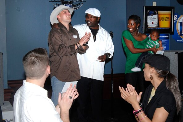 Landon King, (center) 15th Operational Weather Squadron, congratulates second place winner Staff Sgt. Timothy Herrman, AMC, who will represent Scott at the command level competition in October as third place finisher Whitney Striblin, 375th Services Squadron looks on with a smile. 

(US Air Force photo/Senior Airman Jonathan Lovelady)