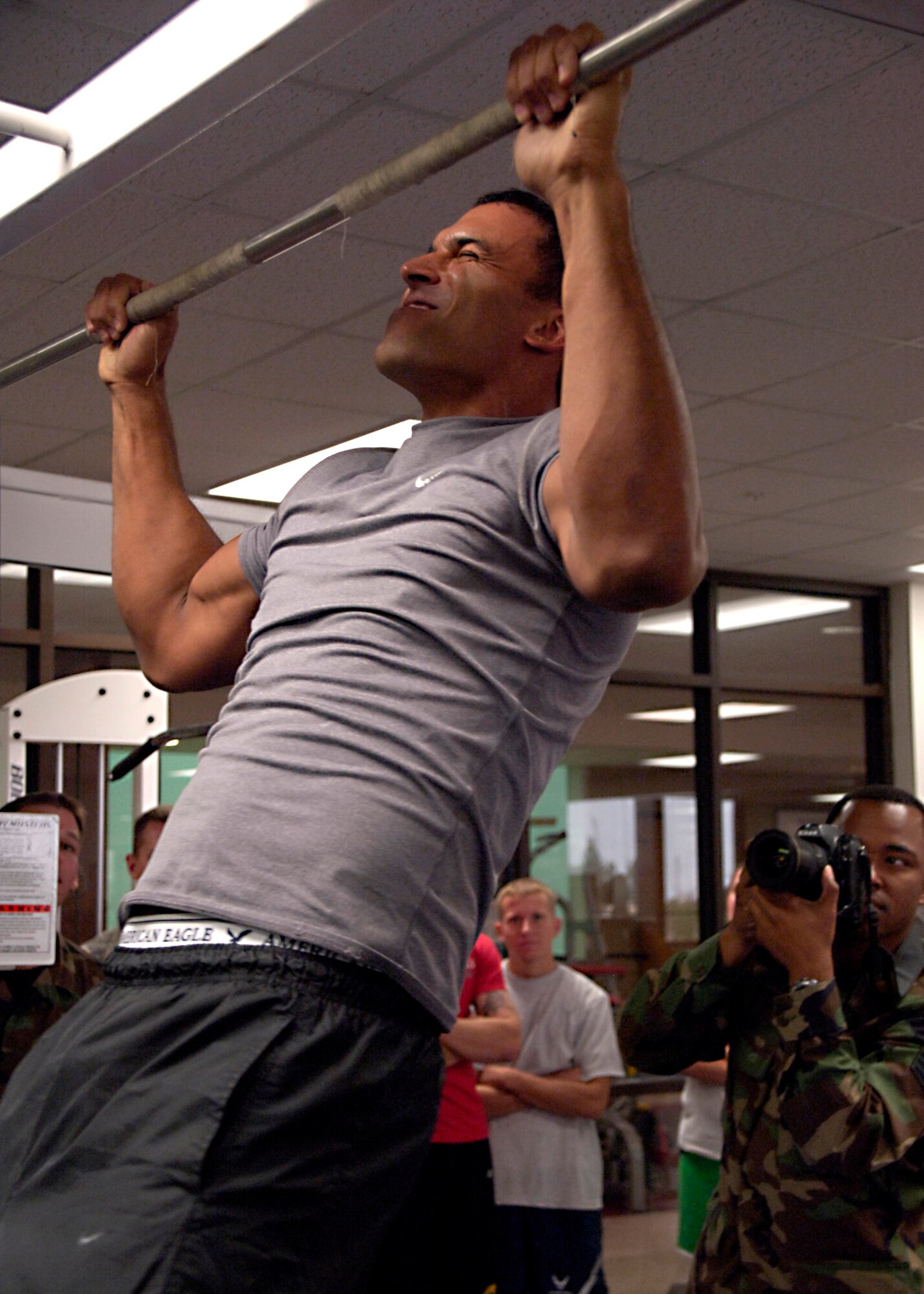 Senior Airman Anthony Nelson photographs Tech. Sgt. Alan Weary, 49th Medical Group, as he competes in the pull up portion the Iron Airman Challenge at Holloman Air Force Base, N.M., Aug. 27. Sergeant Weary completed 21 pull up repetitions during the competition. (U.S. Air Force photo/ Senior Airman Tiffany Trojca)