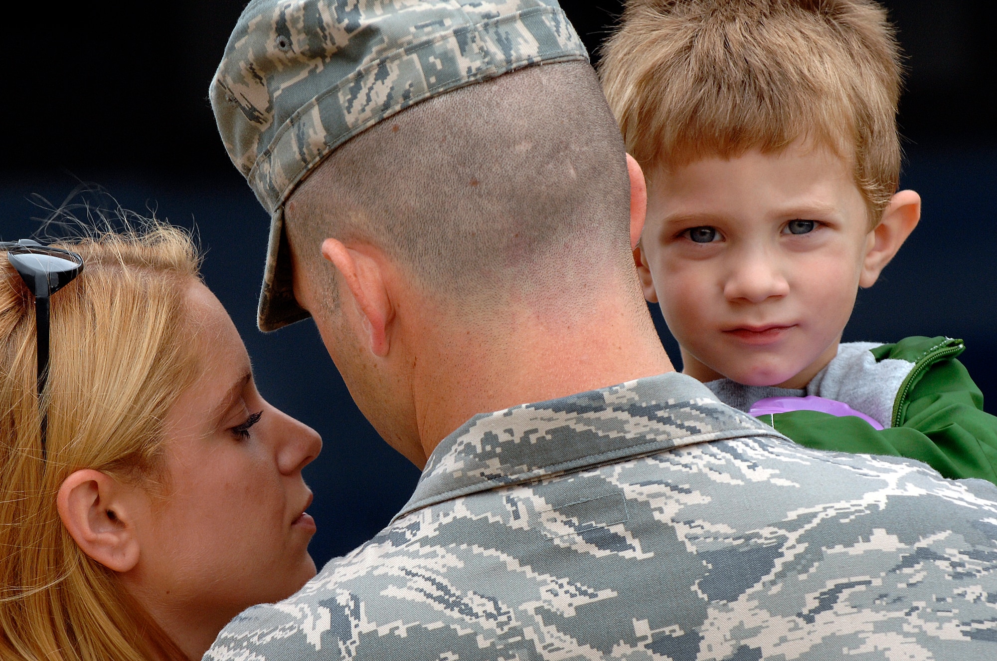 LANGLEY AIR FORCE BASE, Va. -- Staff Sgt. Joshua Finkbeiner, 1st Security Forces Squadron patrolman, holds his son Caleb and wife Amanda before  leaving for a six month deployment to Joint Balad Air Base, Iraq, Aug. 28.  This is Sergeant Finkbeiner's second deployment in support of the Global War on Terrorism. The 13-man team from the 1st SFS is tasked along with 800 Airmen Air Force-wide to relieve Army Soldiers from entry control point and tower patrol duties at Joint Base Balad.  (U.S. Air Force photo/Senior Airman Vernon Young)