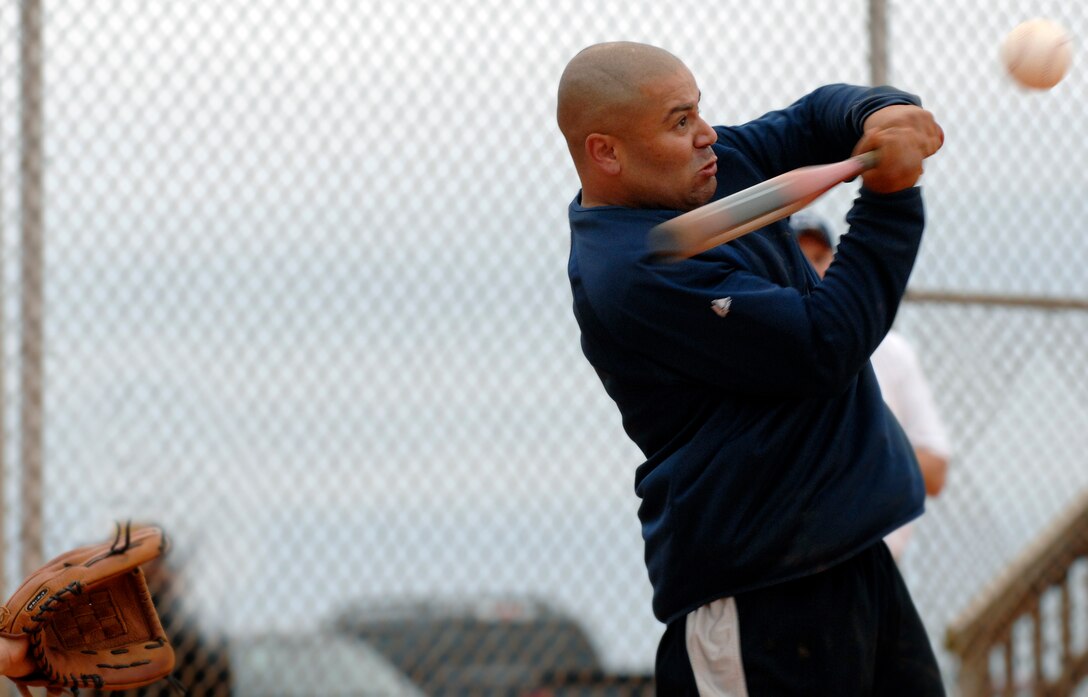 LANGLEY AIR FORCE BASE, Va. -- Staff Sergeant Jaime Torres, 1st Communications Squadron, swings at a pitch from Senior Airman Ricardo Hernandez, 480th Intelligence Wing in a softball playoff game Aug. 26.  Staff Sgt. Torres helped lead the 1st CS to 19-7 victory over the 480th IW as the Langley softball season comes to a close.  (U.S. Air Force photo/Senior Airman Vernon Young)