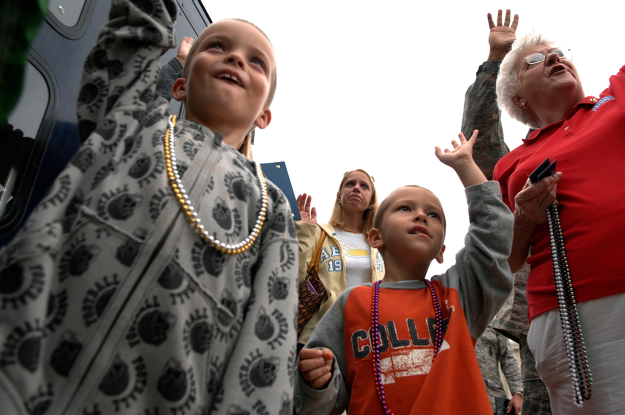 LANGLEY AIR FORCE BASE, Va. -- Military dependants of Airmen of the 1st Security Forces Squadron wave at family as they depart for a six-month deployment to Joint Base Balad, Iraq.  The 13-man team of the 1st SFS are among more than 800 Airmen Air Force-wide tasked to relieve Army Soldiers from entry control point and tower patrol duties.  (U.S. Air Force photo/Senior Airman Vernon Young)