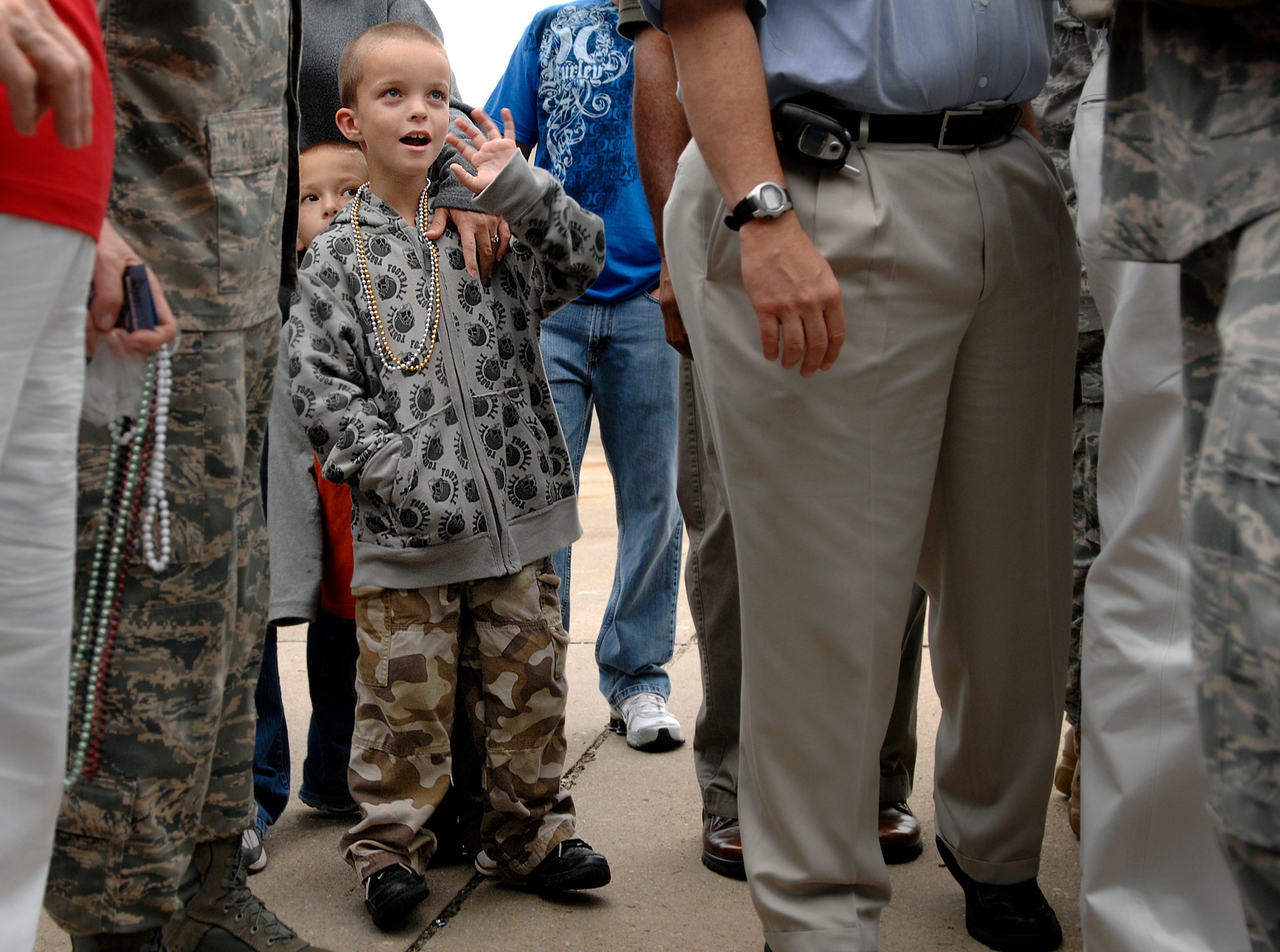 LANGLEY AIR FORCE BASE, Va. -- Brendan and Tyler Miller, sons of Senior Airman Paul Miller, 1st Security Forces Squadron patrolman, wave to their father as he depart for a six-month deployment to Joint Base Balad, Iraq, Aug. 28.  The 13-man team from the 1st SFS is tasked along with 800 Airmen Air Force-wide to relieve Army Soldiers from entry control point and tower patrol duties at Joint Base Balad.  Senior Airman Miller and family also celebrated his surprise below-the-zone promotion to senior airman. (U.S. Air Force photo/Senior Airman Vernon Young) 