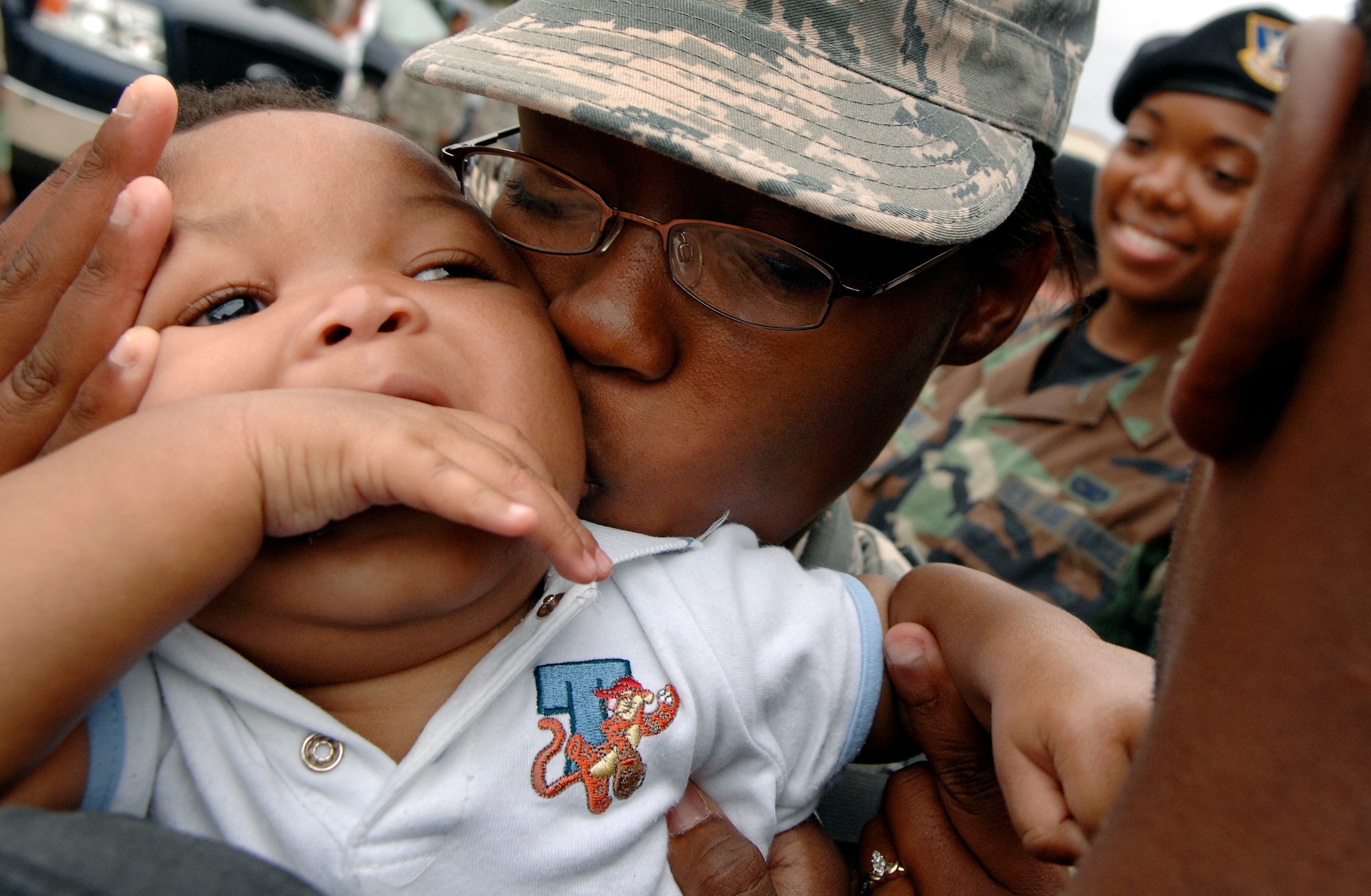 LANGLEY AIR FORCE BASE, Va. -- Airman 1st Class Jasman Williams, 1st Security Forces patrolman, embraces her son Micah before deploying to Joint Base Balad, Iraq, Aug. 28.  The 13-man team from the 1st SFS is tasked along with 800 Airmen Air Force-wide to relieve Army Soldiers from entry control point and tower patrol duties at Joint Base Balad.  (U.S. Air Force photo/Senior Airman Vernon Young)