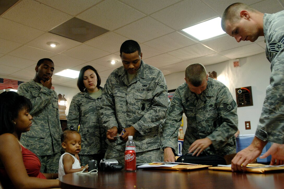 LANGLEY AIR FORCE BASE, Va. -- Airmen of the 1st Security Forces Squadron sort through deployment itinerary information before departing for a six-month deployment to Joint Base Balad, Irag, Aug. 28.   The 13-man team from the 1st SFS is tasked along with 800 Airmen Air Force-wide to relieve Army Soldiers from entry control point and tower patrol duties at Joint Base Balad.  (U.S. Air Force photo/Senior Airman Vernon Young)
