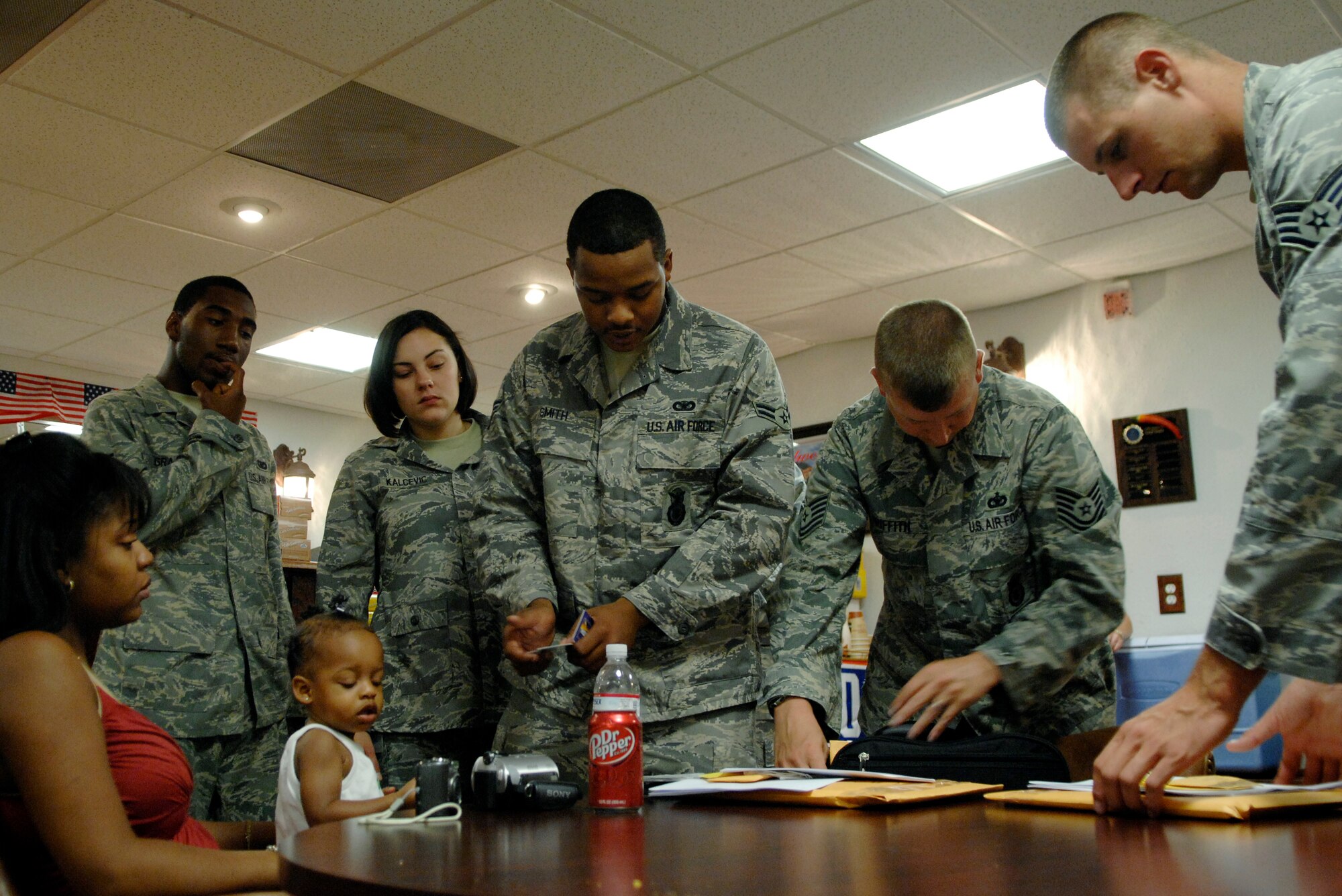 LANGLEY AIR FORCE BASE, Va. -- Airmen of the 1st Security Forces Squadron sort through deployment itinerary information before departing for a six-month deployment to Joint Base Balad, Irag, Aug. 28.   The 13-man team from the 1st SFS is tasked along with 800 Airmen Air Force-wide to relieve Army Soldiers from entry control point and tower patrol duties at Joint Base Balad.  (U.S. Air Force photo/Senior Airman Vernon Young)