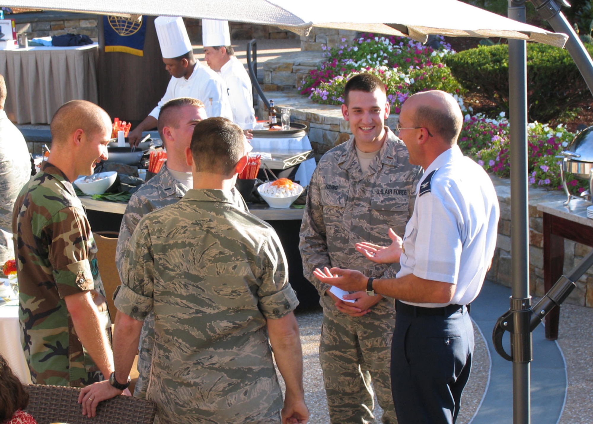 BEDFORD, Mass. -- Hanscom Air Force Base company grade officers and members of the Young AFCEANS speak with Brig. Gen. select Terry Feehan, Electronic Systems Center vice commander,  during the yearly social held for the Lexington-Concord chapter for the Armed Forces Communications and Electronics Association, Aug. 27. AFCEA is a non-profit international association composed of military, civil service and industry members working in the fields of information technology, communications and intelligence. (U.S Air Force photo by J.C. Corcoran)