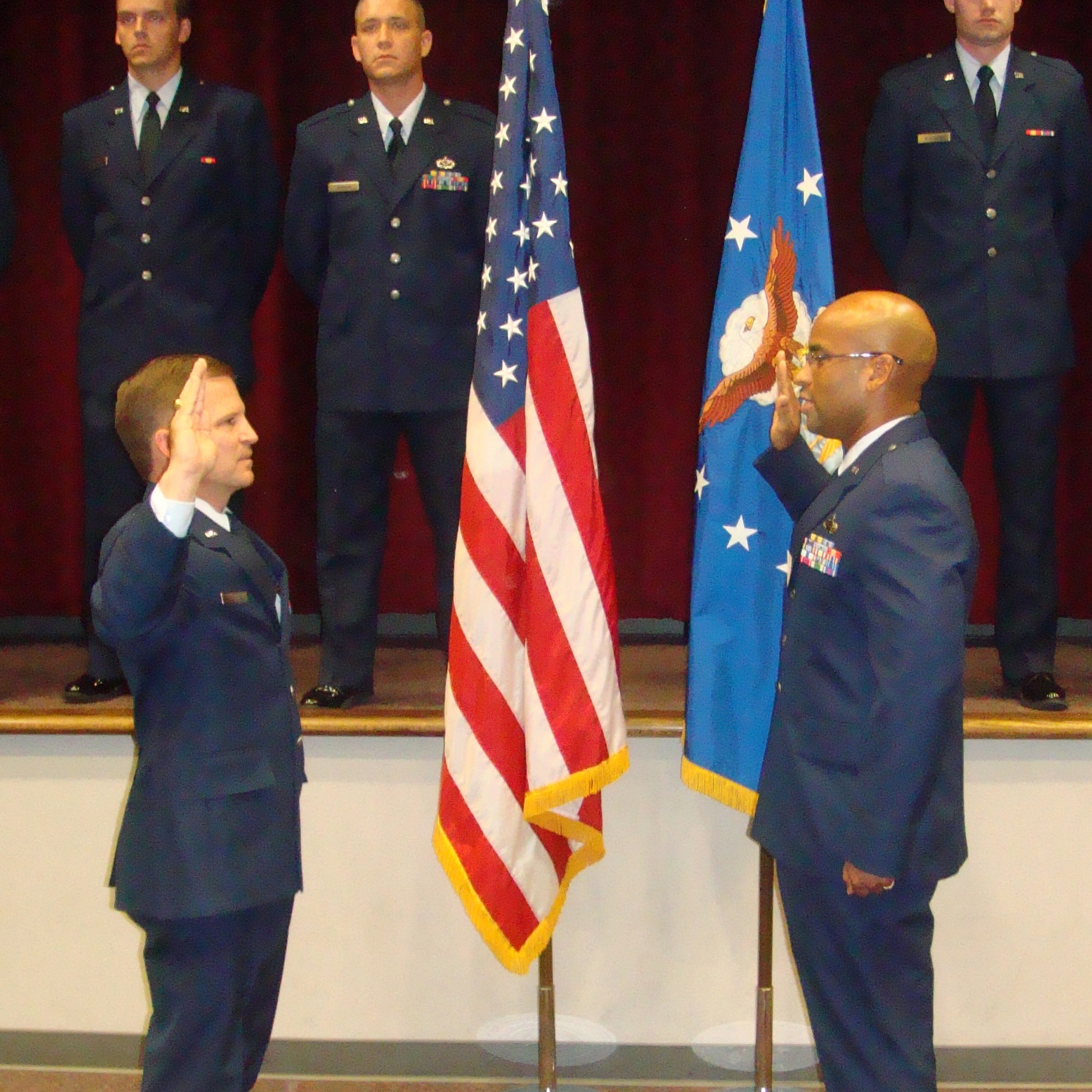 EGLIN AFB, Fla. -- Retired Col. Jeffrey Watson commissions Julian Glover as a second lieutenant during a ceremony at Maxwell AFB, Ala. The men became friends while working in civil service positions here. (courtesy photo)
