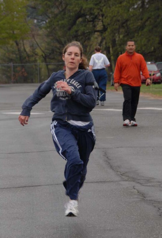 Staff Sgt Dawn M. Whelan crosses the finish line as 1Lt David J. Ferrer looks on during the. (Air Force photos by Staff Sgt Erin E. McNamara)  