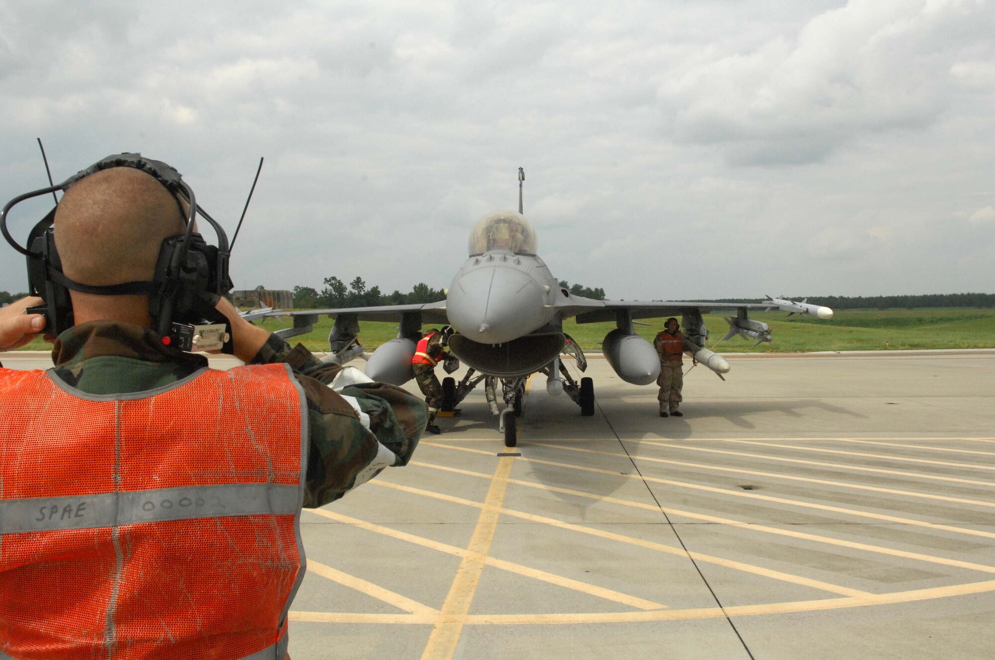 SHAW AIR FORCE BASE, S.C. -- Staff Sgt. John Lance, 20th Aircraft Maintenance Squadron, communicates with the pilot while other Airmen perform final checks at the end of runway before the aircraft takes off during a Phase II Operational Readiness Exercise Aug. 26. OREs provide vital training and prepare Airmen for worldwide deployment. (U.S. Air Force photo/Senior Airman William Coleman)