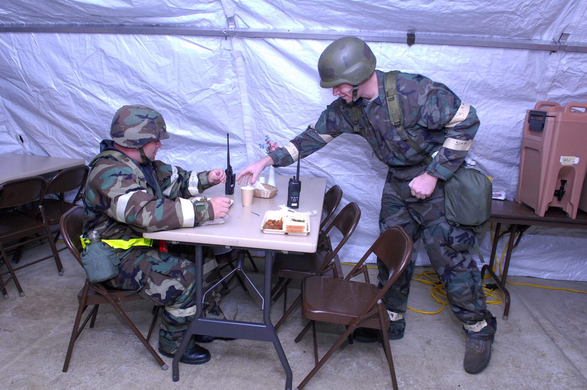 SHAW AIR FORCE BASE, S.C. -- Master Sgt. David Sinay and 1st Lt. Daniel Connors, 20th Equipment Maintenance Squadron, eat hot meals in a field kitchen during a Phase II Operational Readiness Exercise Aug. 26. OREs provide vital training and prepare Airmen for worldwide deployment. (U.S. Air Force photo/Senior Airman William Coleman)