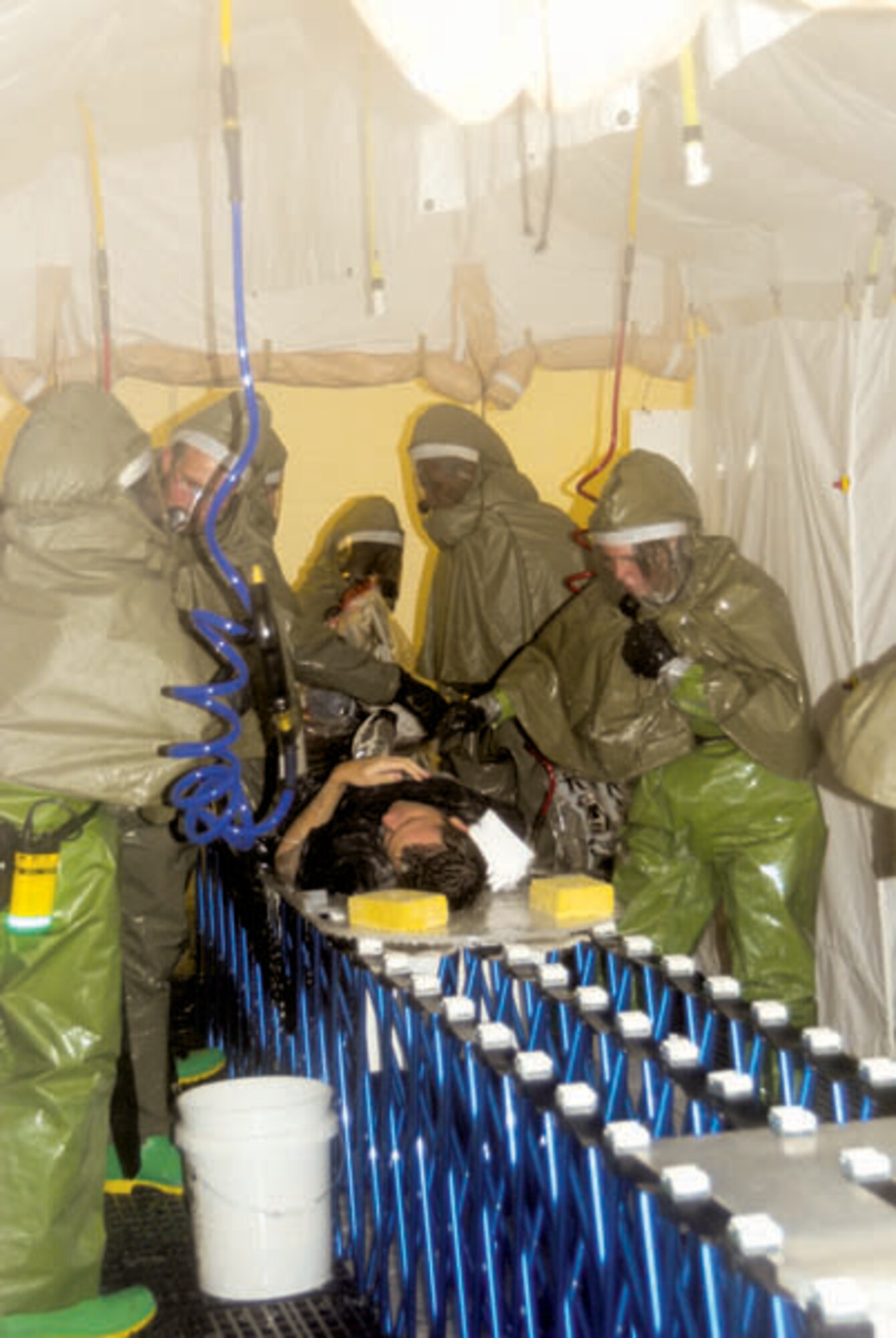 The In-Place Patient Decontamination team processes patients though decontamination to remove any hazardous chemical contact before admitting the people into the clinic for treatment by the other response teams. The Medical Emergency Response Capabilities and Assessment Training included most of the 90th Medical Group and more than 150 volunteer patients. 