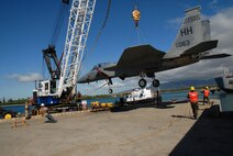 The Hawaii Air National Guards F-15 A, number 76-0063, is hoisted onto a barge at Hickam Air Force Base on August 26, 2008.  The fighter jet is a donation to the Pacific Aviation museum's collection of historic aircraft.  It was delivered to the USAF in 1977 and assigned to the 49th Tactical Fighter Wing (TFW) at Holloman AFB, New An F-15 Eagle is hoisted onto a barge Aug. 26 at Hickam Air Force Base, Hawaii. The fighter jet is a donation to the Pacific Aviation museum's collection of historic aircraft. It was delivered to the Air Force in 1977 and initially assigned to the 49th Tactical Fighter Wing at Holloman AFB, N.M. It flew with the 8th and 9th Fighter Squadrons of the 49th TFW at Holloman AFB where it served as the wing flagship and had painted on its fuselage "City of Alomogordo.' When the 49th TFW transitioned to the F-117 Nighthawk, 76-0063 was transferred to the Hawaii Air National Guard in June 1992. (U.S. Air Force photo/Master Sgt. Kristen Stanley)