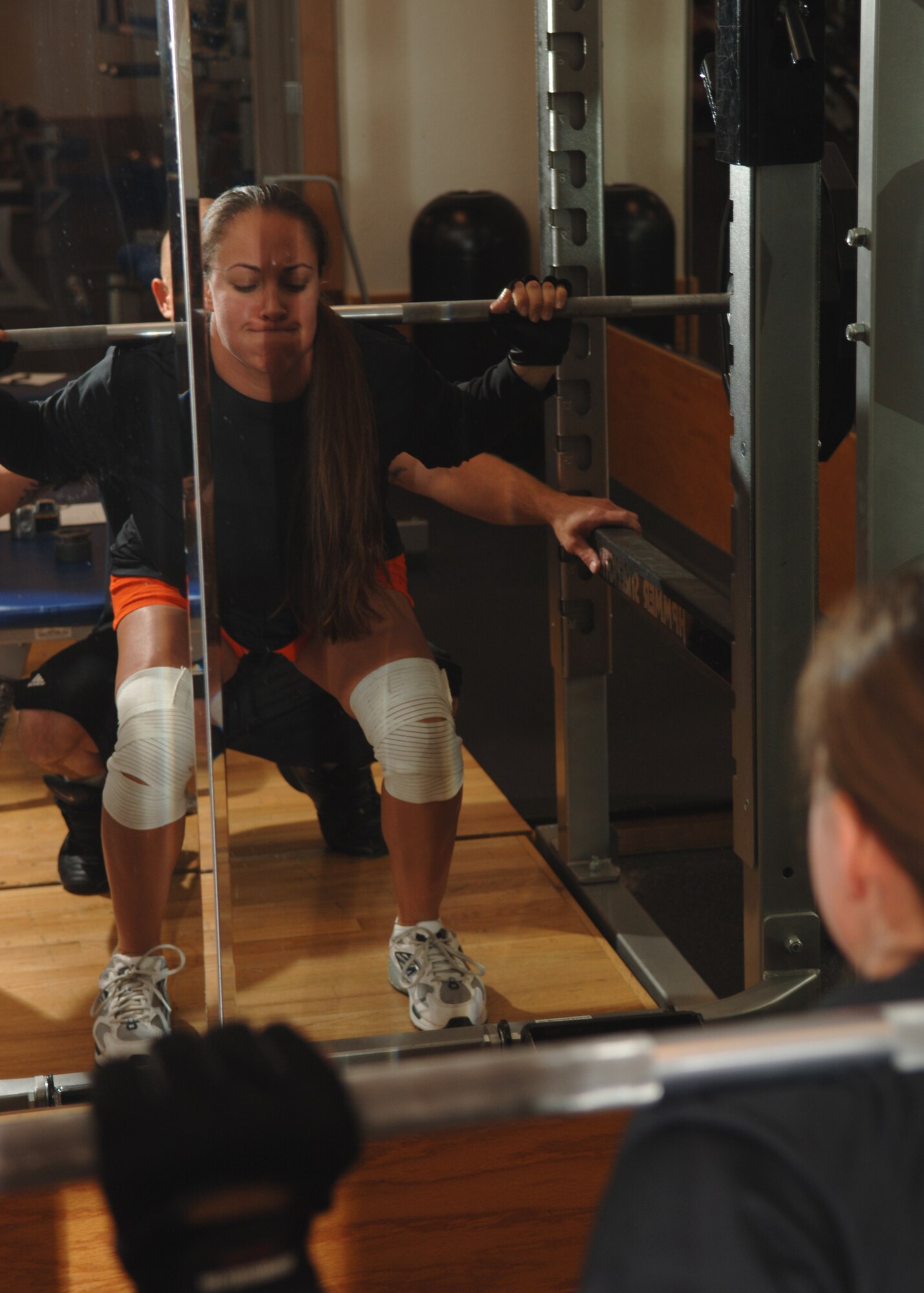 MINOT AIR FORCE BASE, N.D. -- Jessica Cervantez, 5th Civil Engineer Squadron fire fighter, performs a squat exercise during the weightlifting competition here Aug. 27. Jessica took first place in the competition for the 148 to 164 lbs. weight class by squatting 250 lbs. and bench pressing 175 lbs. (U.S. Air Force photo by Senior Airman Sharida Jackson)
