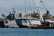 An F-15 Eagle gets a lift from a barge crane for its vogue to the Pacific Aviation Museum Pearl Harbor on Ford Island in Hawaii Aug. 26 at the cargo pier at Hickam Air Force Base, Hawaii. The aircraft was from the 199th Fighter Squadron of the Hawaii Air National Guard. (U.S. Air Force photo/Master Sgt. Robert Burgess) 