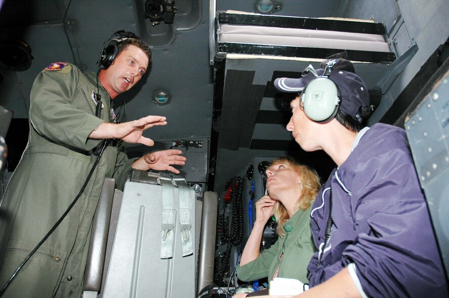 Capt. Mitchell Maes, 934th Operations Support Flight, explains headphone use to Tammy Hauer (right), wife of Robert Hauer, 27 APS, and Teresa Rettman, wife of Ben Rettman, 934 AMXS during a Spouse Flight on Sunday of the August UTA. (Air Force Photo/Tech. Sgt. Jeff Williams)
 