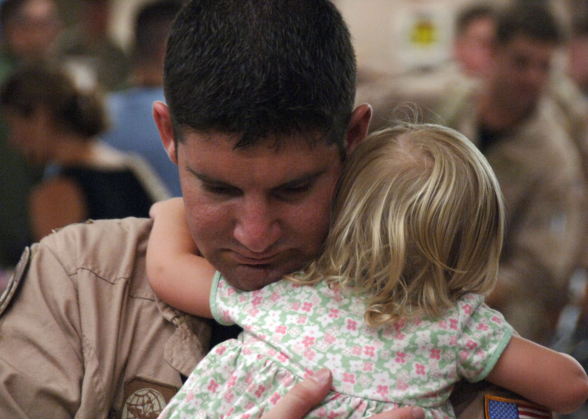 Capt. James Salazar hugs his 20-month-old daughter, Elizabeth, prior to the 15th Airlift Squadron's departure Aug. 27 at Charleston Air Force Base, S.C. Captain Tarkowski is assigned to the 15th AS. (U.S. Air Force photo/Airman 1st Class Timothy Taylor) 
