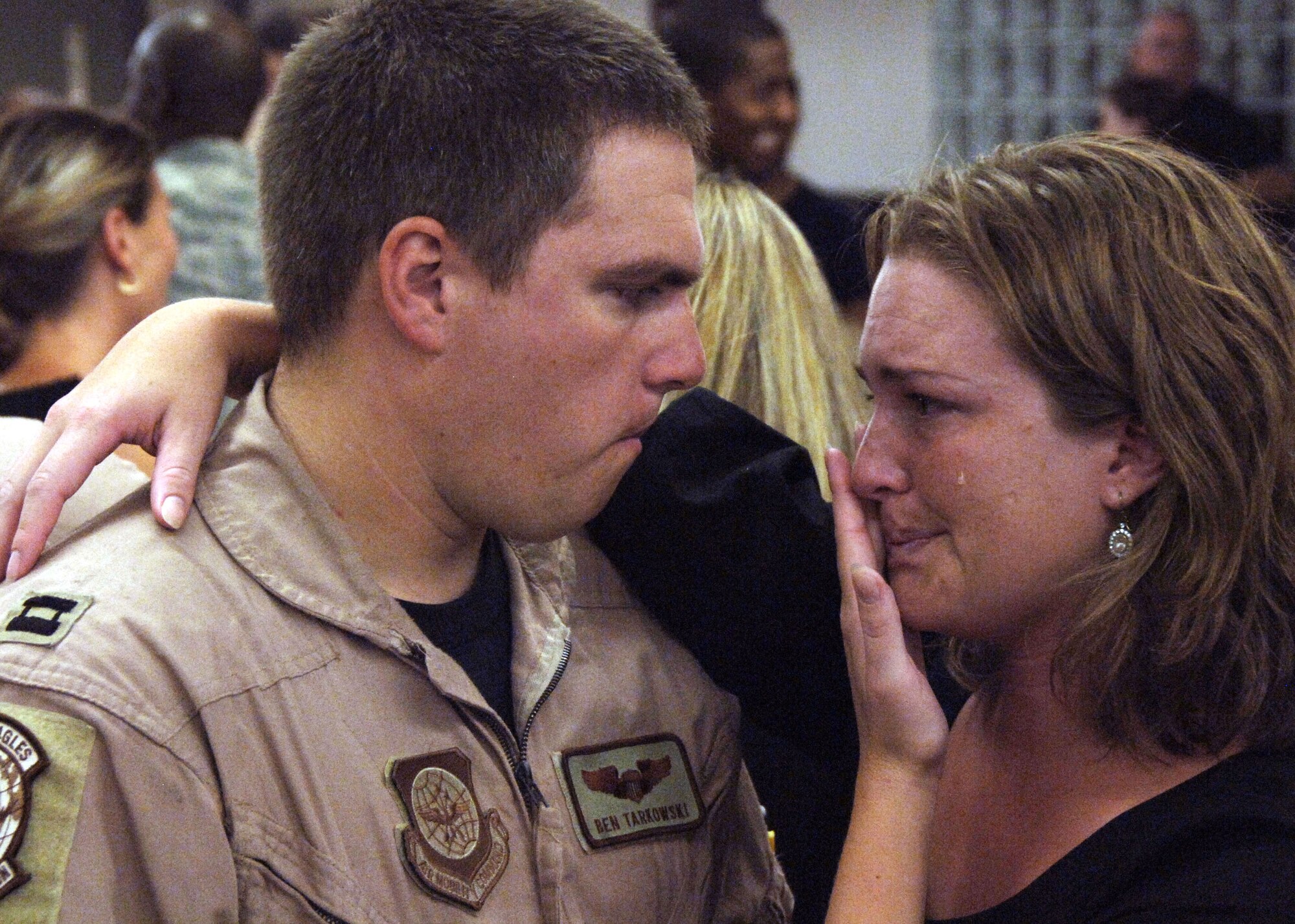 Capt. Ben Tarkowski and wife, Ericka, say their goodbyes before leaving each other's side Aug. 27 at Charleston Air Force Base, S.C. Members of the 15th Airlift Squadron are deploying to Southwest Asia and will replace the 14th Airlift Squadron from Charleston AFB, who will be returning home. Captain Tarkowski is with the 15th AS. (U.S. Air Force photo/Airman 1st Class Timothy Taylor) 

