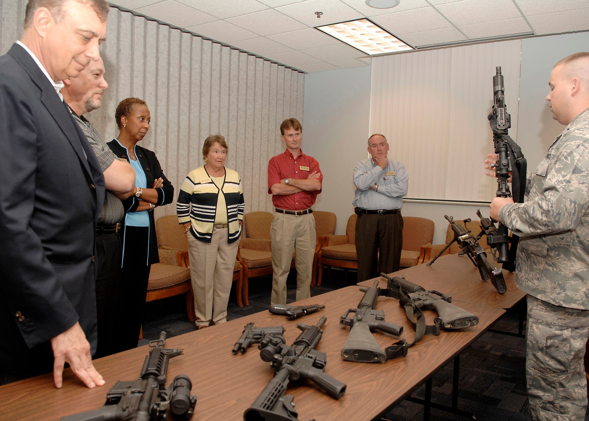 Pope honorary commander Johnny Dawkins (second from right) and civic leaders from communities around other Air Mobility Command bases listen to a briefing on the type of weapons usually issued during a Mobility Processing Line. Mr. Dawkins was part of the AMC Civic Leader Conference held at Scott Air Force Base, Ill., Aug. 17-19. The purpose of the conference was to provide individual advice to the AMC Commander and commanders at all levels and to develop relationships. (U.S. Air Force Photo from Air Mobility Command Public Affairs)